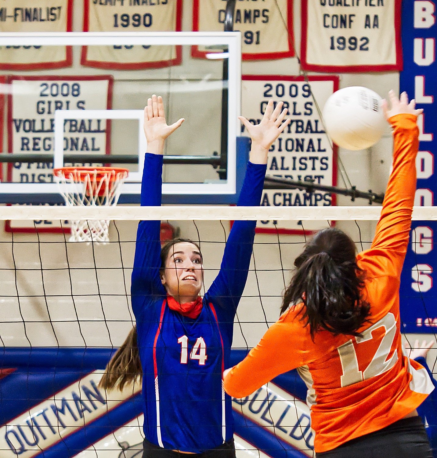 Ava Burroughs (14) defends the net against the shot of Brittany Pickle (12) on Friday.